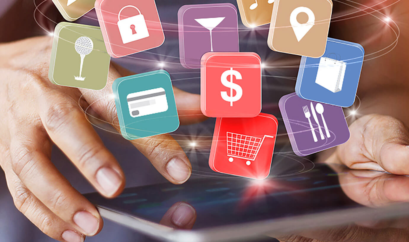 Icons floating above person using tablet