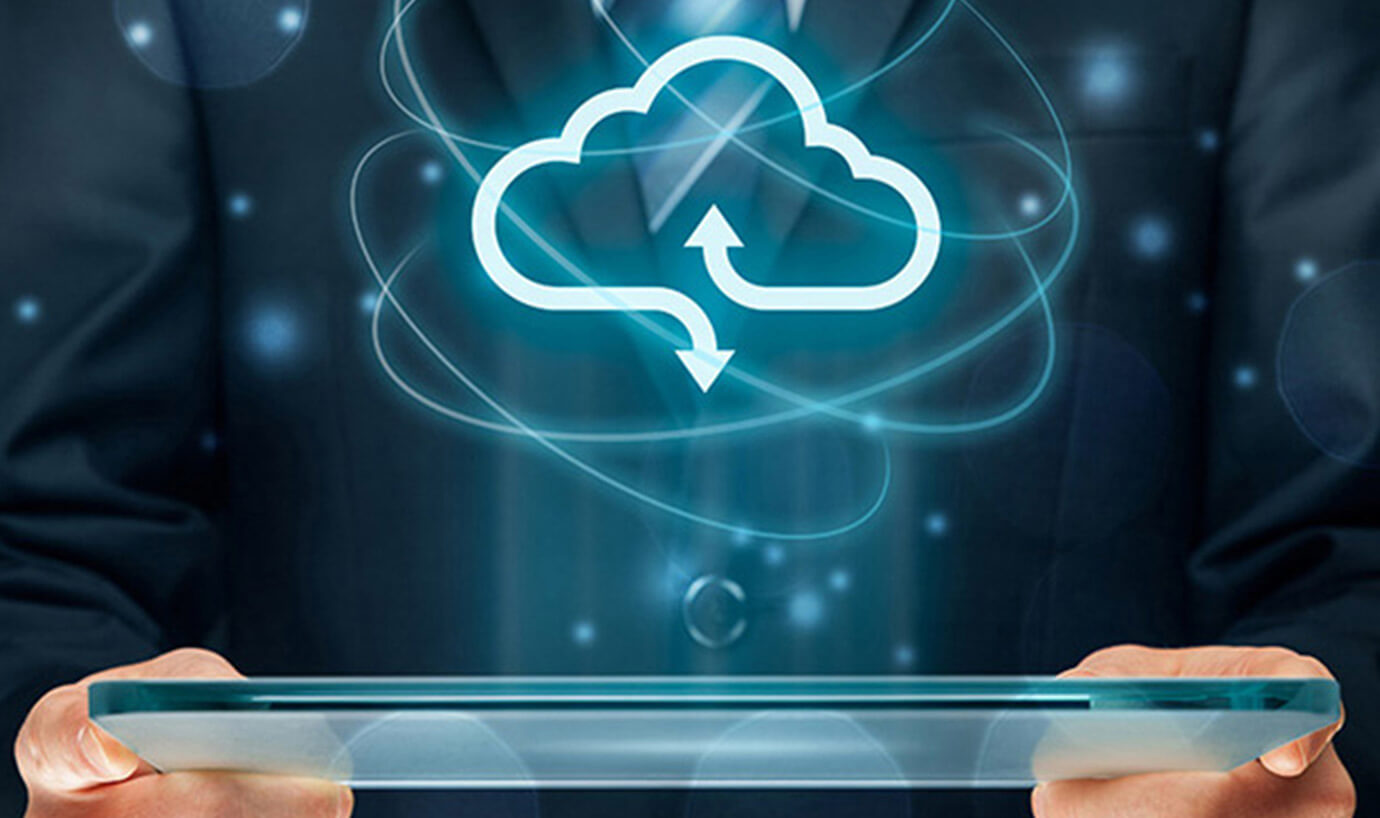 Person on laptop with cloud icon in the foreground